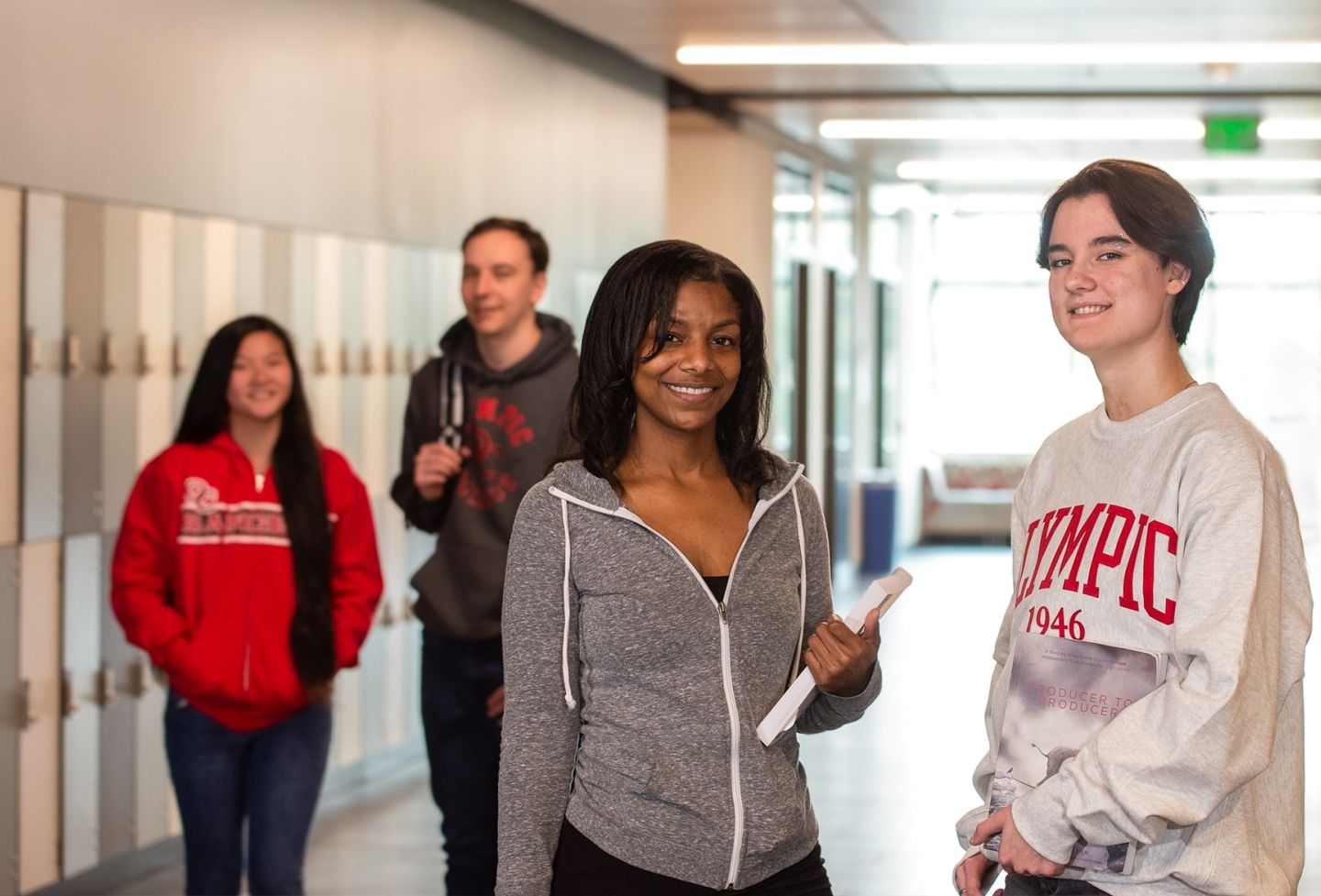 Four students in a hallway together.