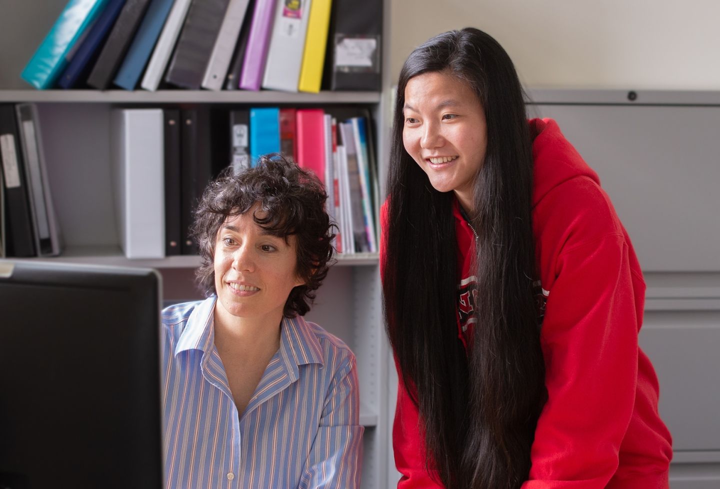 Teacher and student at computer