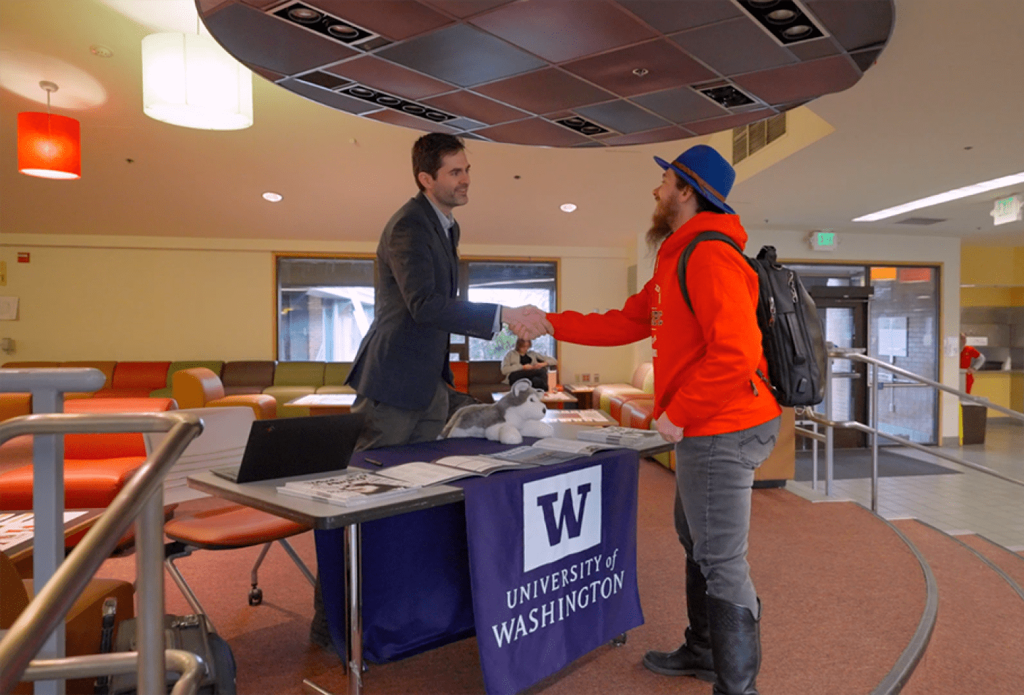Advisor and student shaking hands
