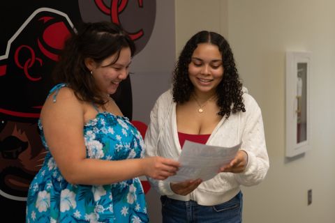 Photo of two people looking at a document together