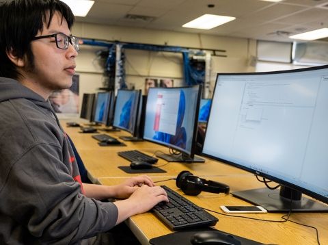 Student working at a computer lab work station