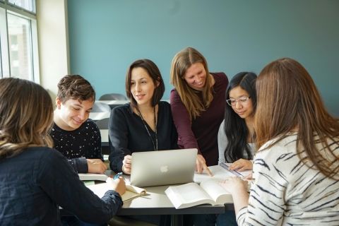 Faculty with students in classroom.