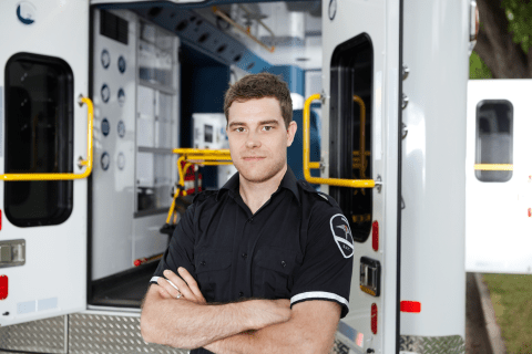 Emergency Medical Technician in front of ambulance
