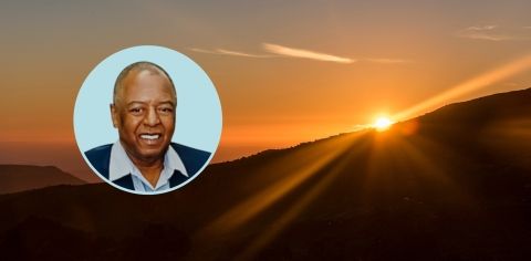 Yellow sunset peeking over a distant hill, with circle graphic containing the authors image.