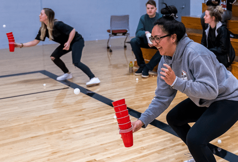Students playing games in gym.