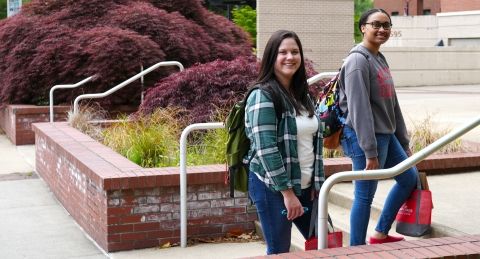 Two students walking on campus.