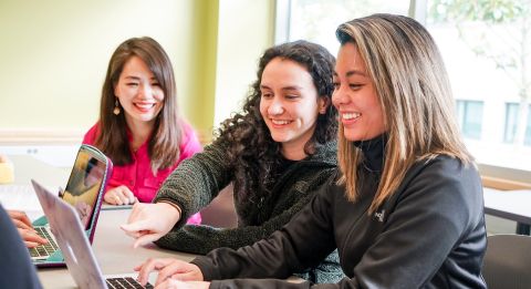Three female students with laptops