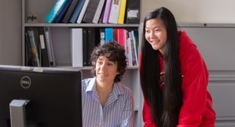 Teacher and student at computer