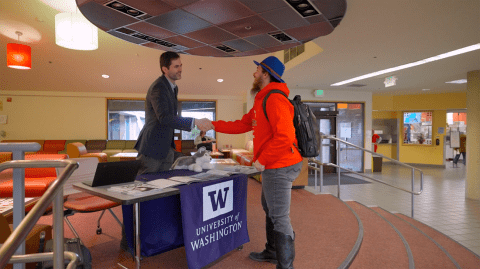 Advisor and student shaking hands
