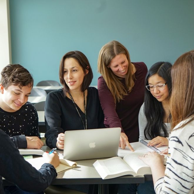 Faculty with students in classroom.