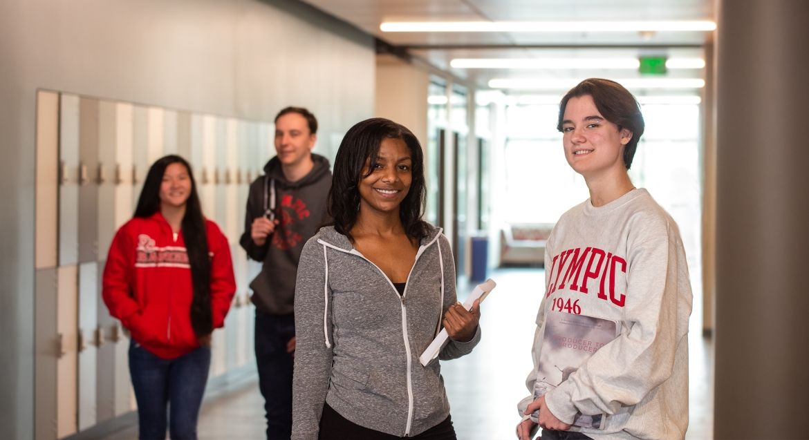 Four students in a hallway together. 