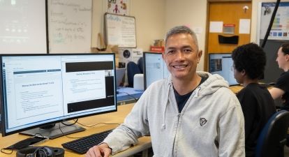 Male student at computer. 